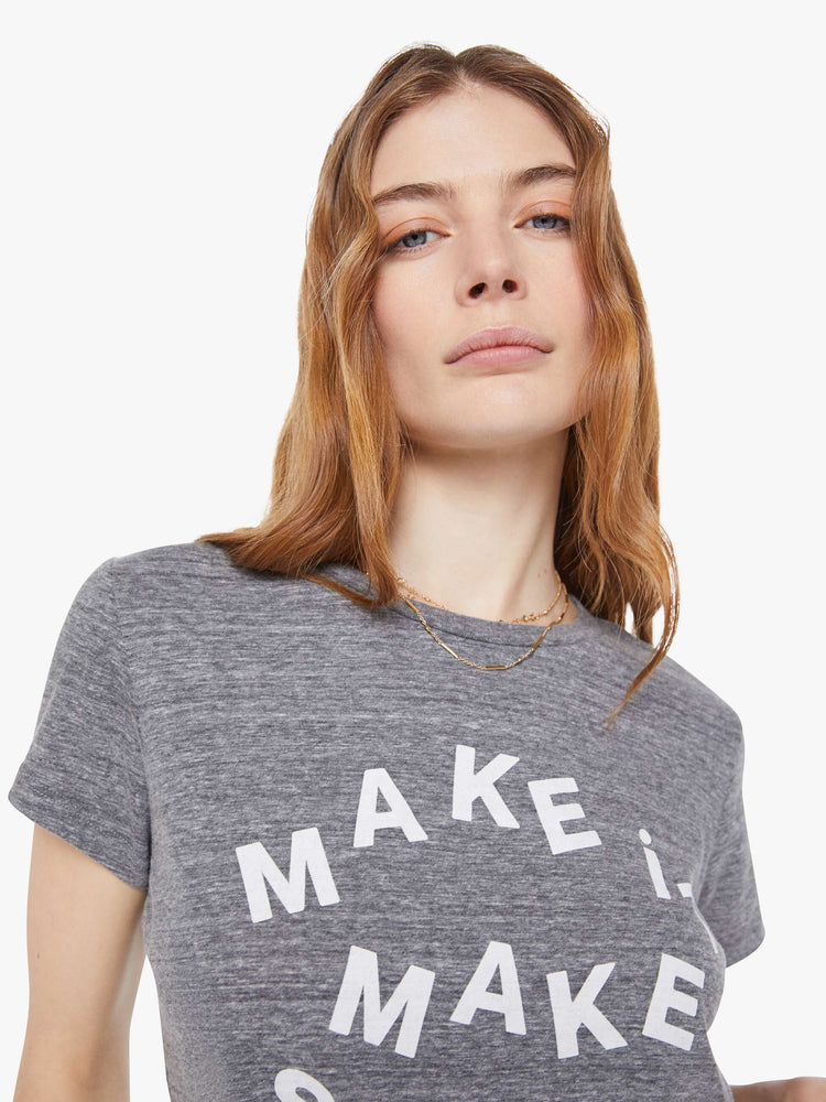 Close up view of a woman in  heathered grey tee features white block text on the front.