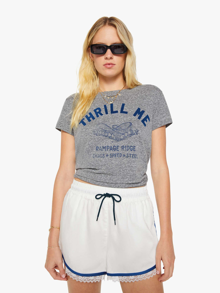 Front view of a woman in a heathered grey, the tee features a rollercoaster graphic and text in a raised, velvety navy-blue texture on the front.