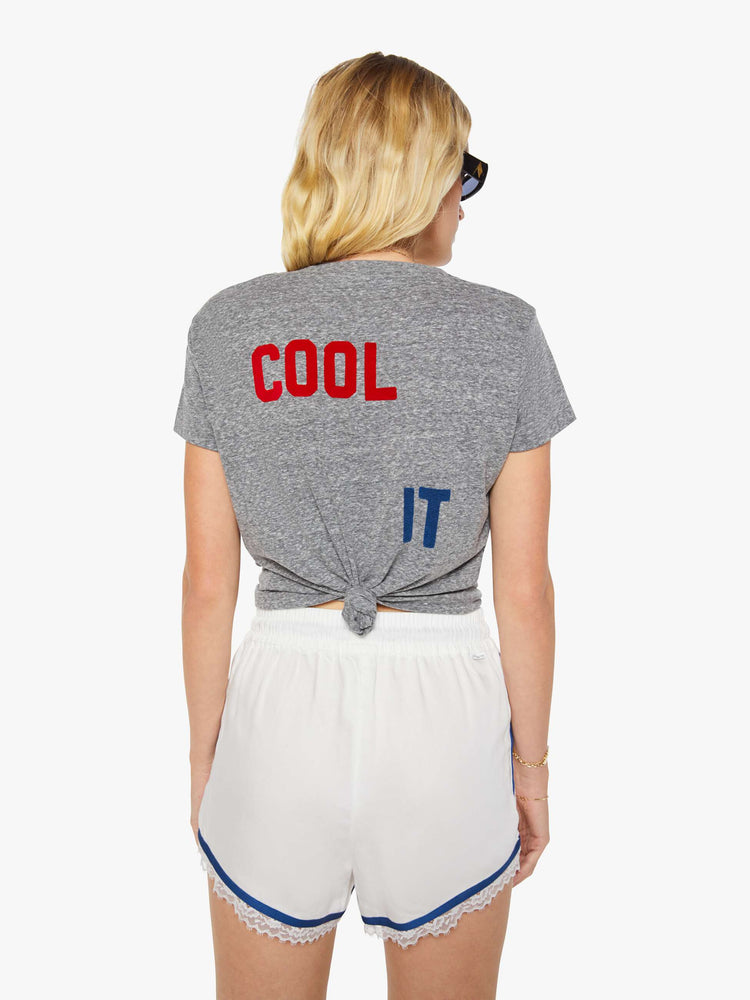 Back view of a woman in a heathered grey, the tee features a rollercoaster graphic and text in a raised, velvety navy-blue texture on the front.