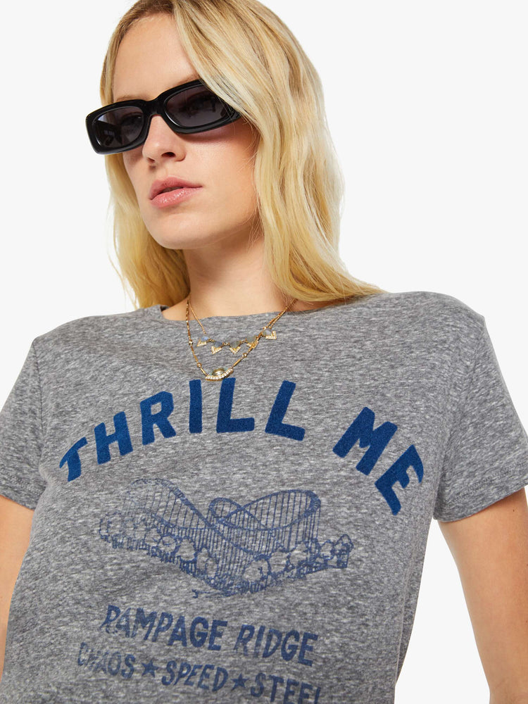 Close up view of a woman in a heathered grey, the tee features a rollercoaster graphic and text in a raised, velvety navy-blue texture on the front.