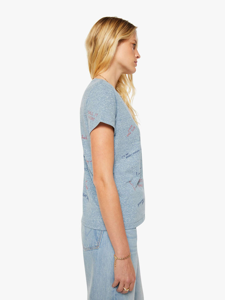 Side view of a woman in an overdyed blue with a printed text tee.