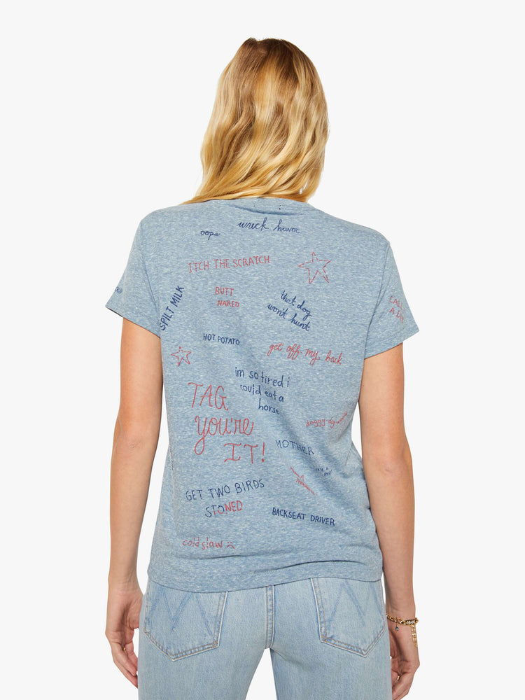 Back view of a woman in an overdyed blue with a printed text tee.
