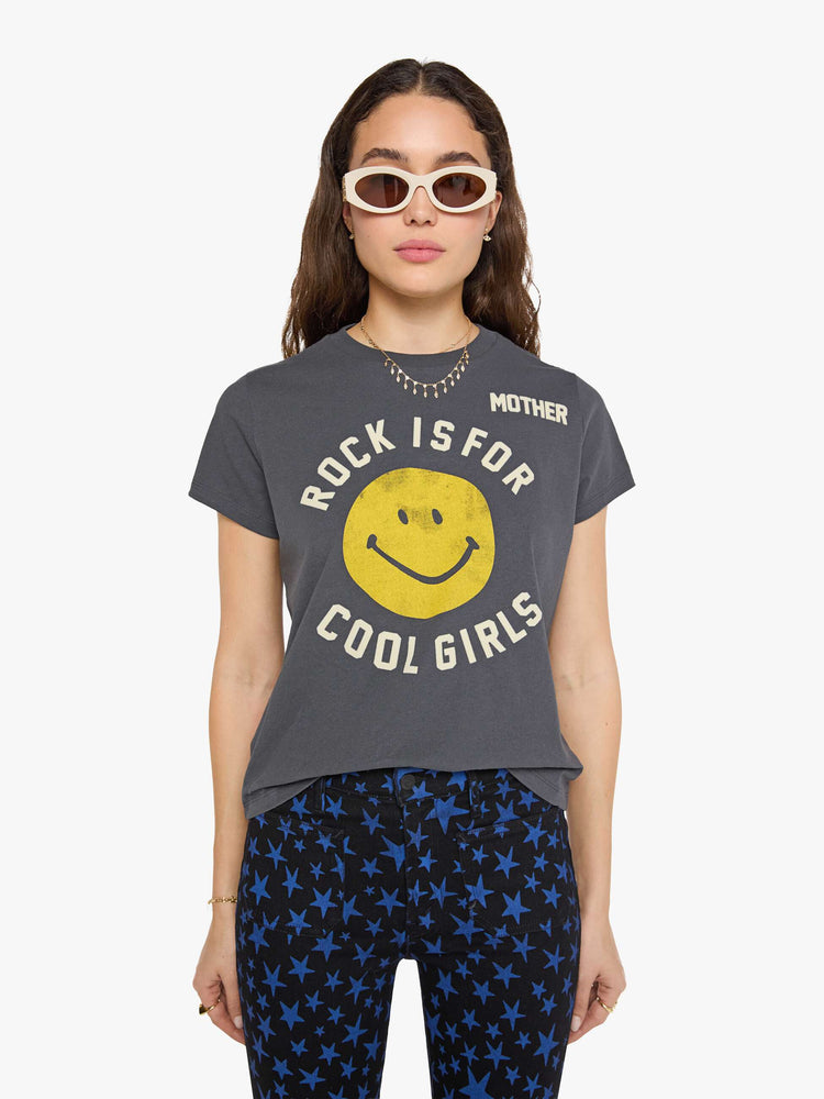 Front view of a woman in faded black tew with a smiley-face graphic and flocked text in white across the chest.
