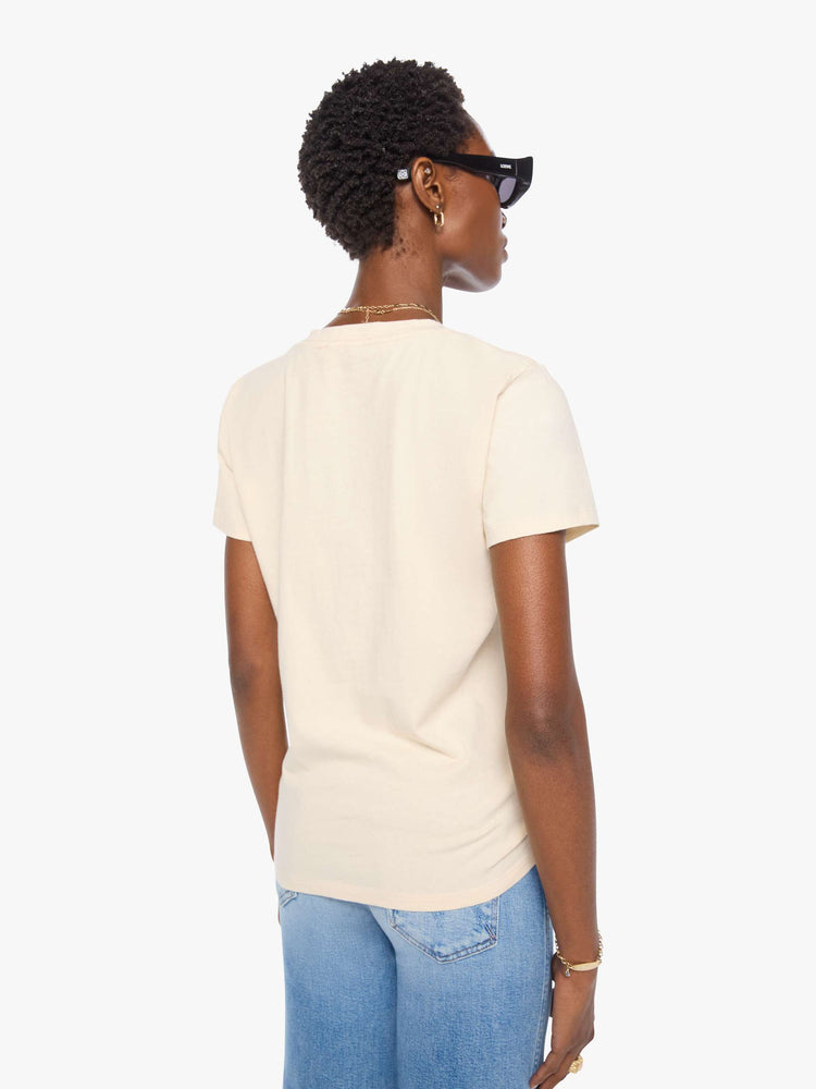 Back view of a woman in a cream tee with a vintage-inspired Western graphic across the chest.