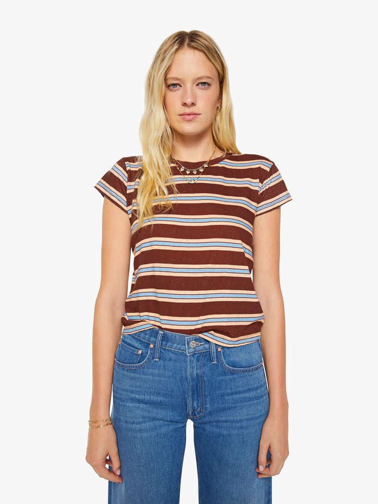 Front view of a woman in a brown tee with printed horizontal stripes in cream and light blue.