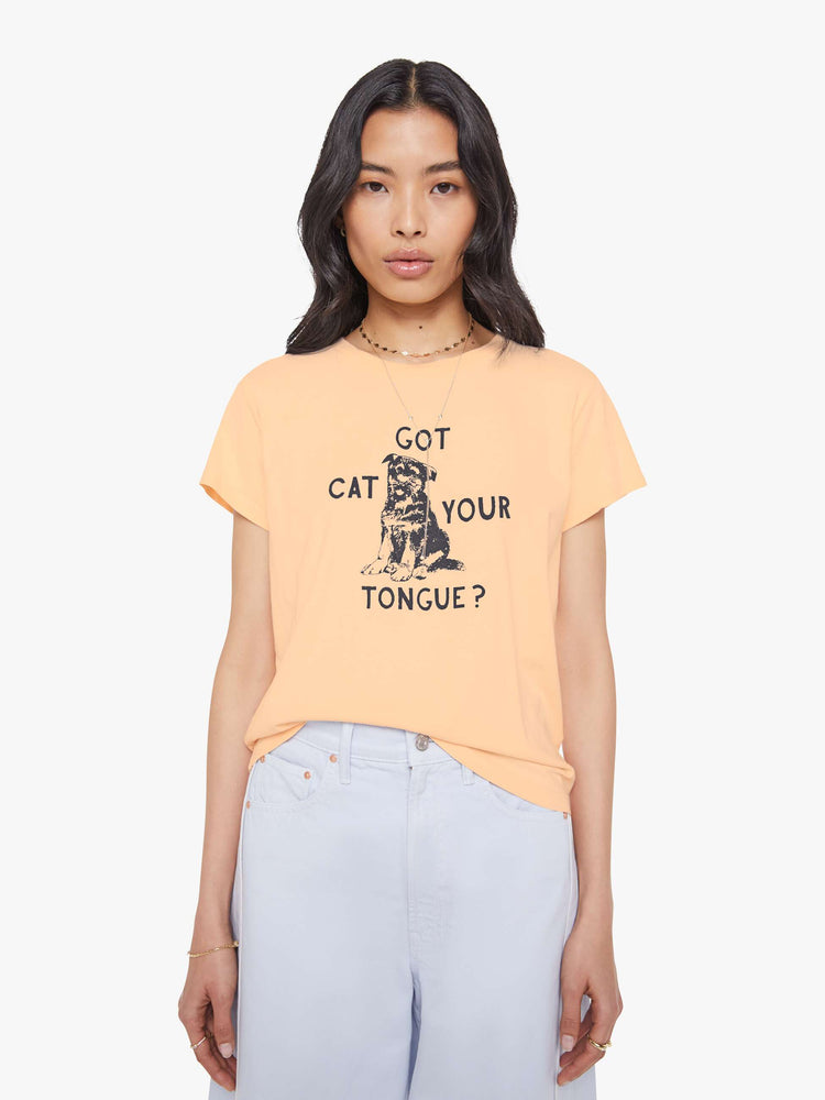 Front view of a woman in light peach, the tee features a black dog graphic with text on the front.