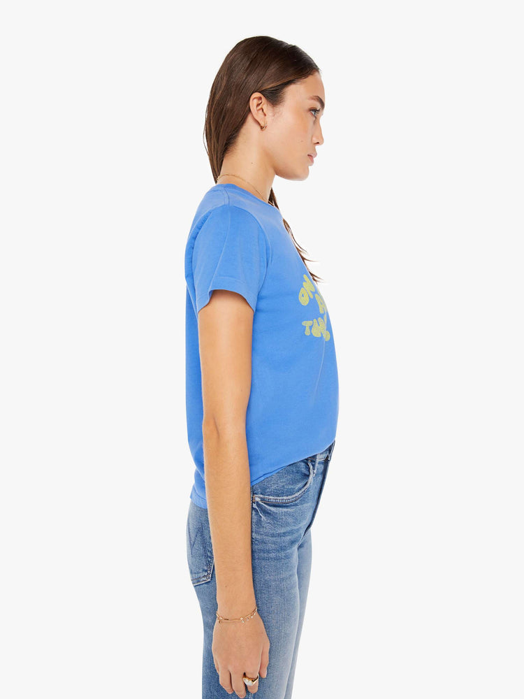 Side view of a womens blue crew neck tee featuring a yellow road graphic.