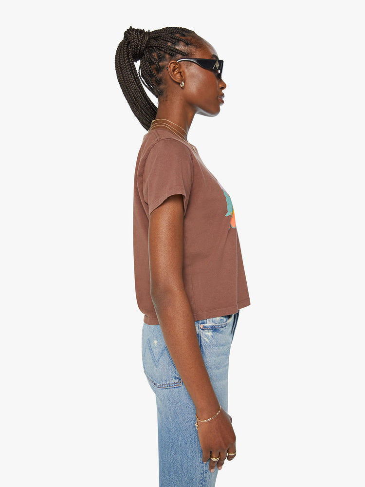 Side view of a woman brown crewneck with a slim fit in a faded graphic sunset.