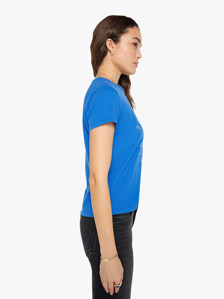 Side view of a woman in a primary blue tee is designed with a glittery silver graphic inspired by a vintage record store.
