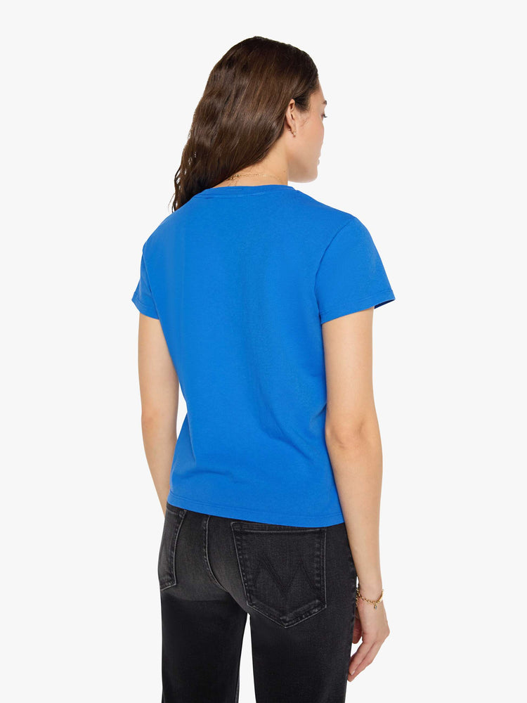 Back view of a woman in a primary blue tee is designed with a glittery silver graphic inspired by a vintage record store.