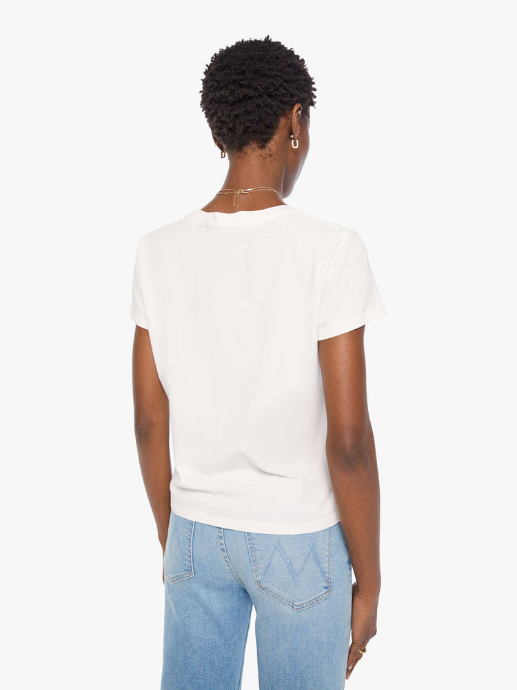 Back view of a woman bright white with a rainbow celestial graphic across the chest tee.