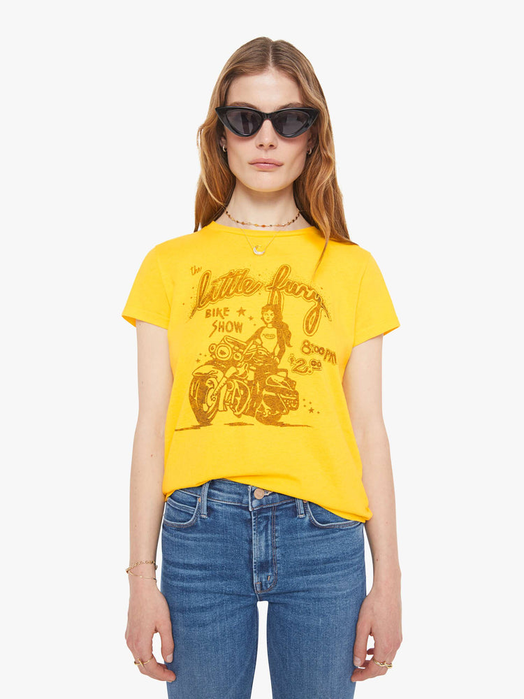 Front view of a woman in bright yellow, the tee features a bike show graphic in tan on the front.