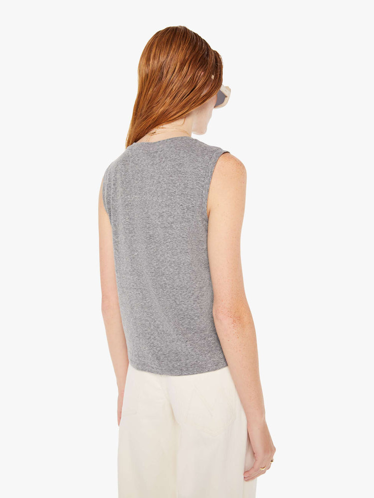 A back view of a woman wearing a heather grey crew neck tank, paired with off white jeans.