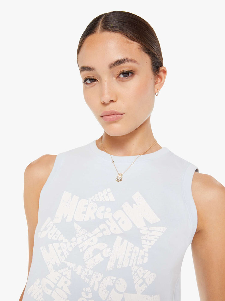 Front close up view of a womens light blue tank top tee featuring a cropped fit and a large white graphic.