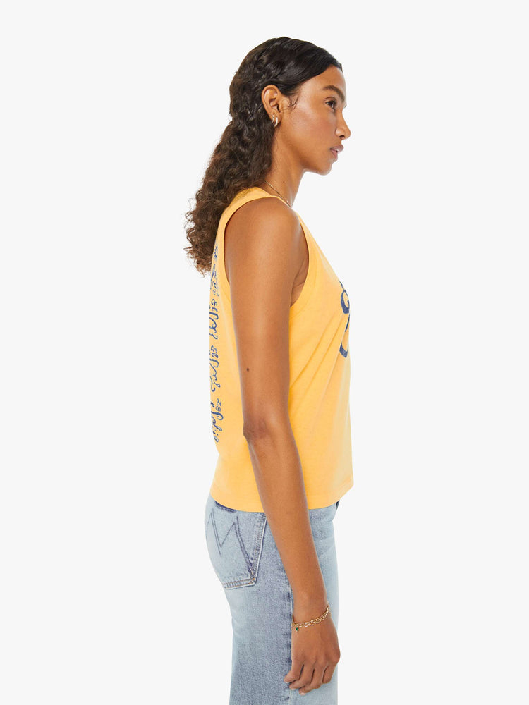 Side view of a woman in a yellow cropped muscle tee that features "El Sol" text in blue.