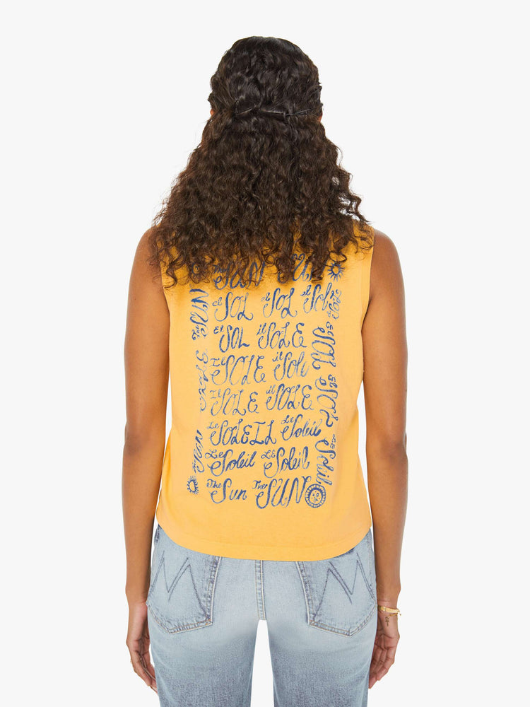 Back view of a woman in a yellow cropped muscle tee that features "El Sol" text in blue.