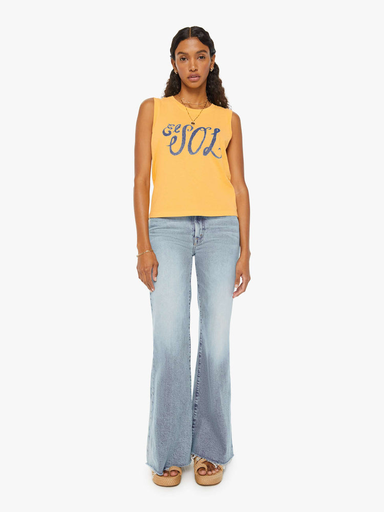 Full front view of a woman in a yellow cropped muscle tee that features "El Sol" text in blue.