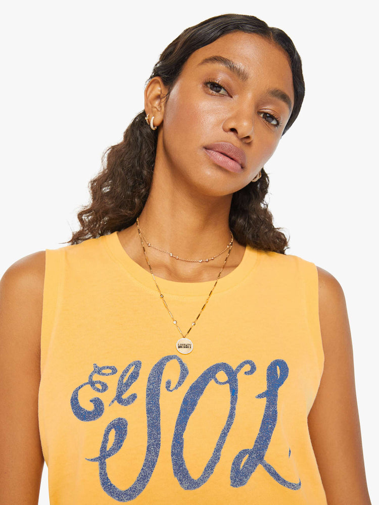 Detailed front view of a woman in a yellow cropped muscle tee that features "El Sol" text in blue.