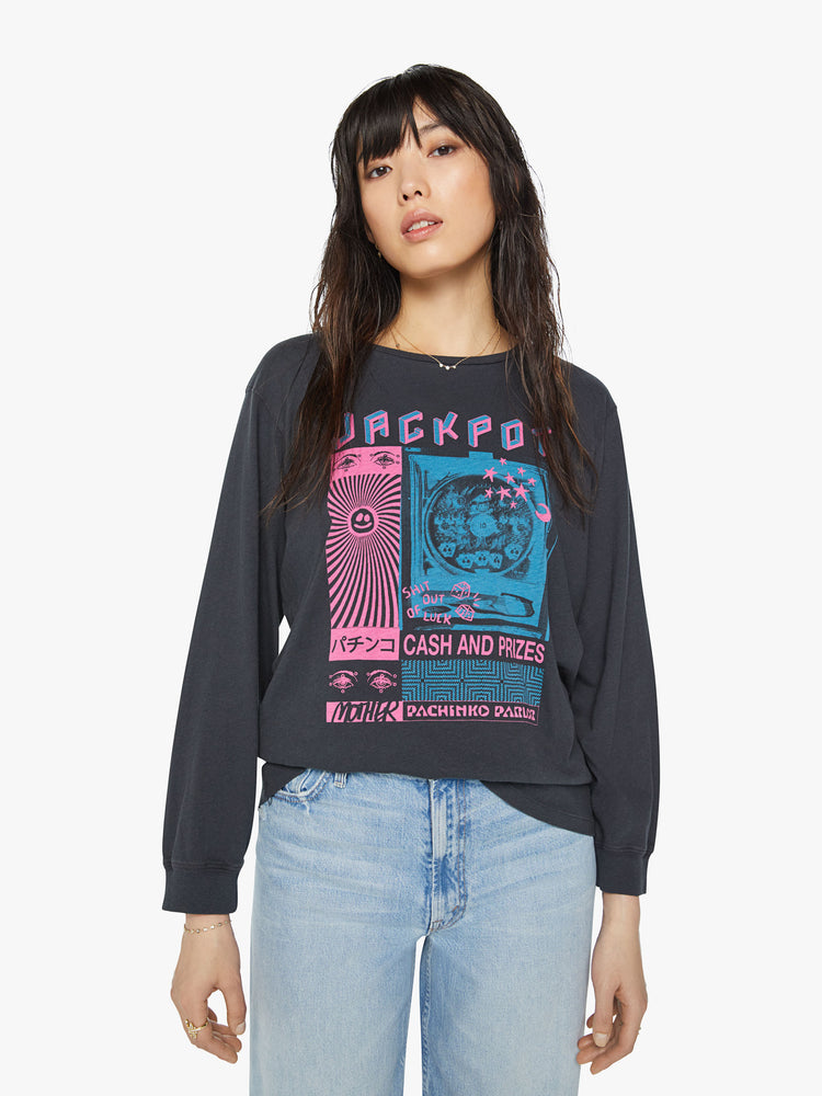 Front view of a woman crewneck tee with an oversized fit in a faded black tee features neon pink and blue graphics inspired by a pachinko parlor.