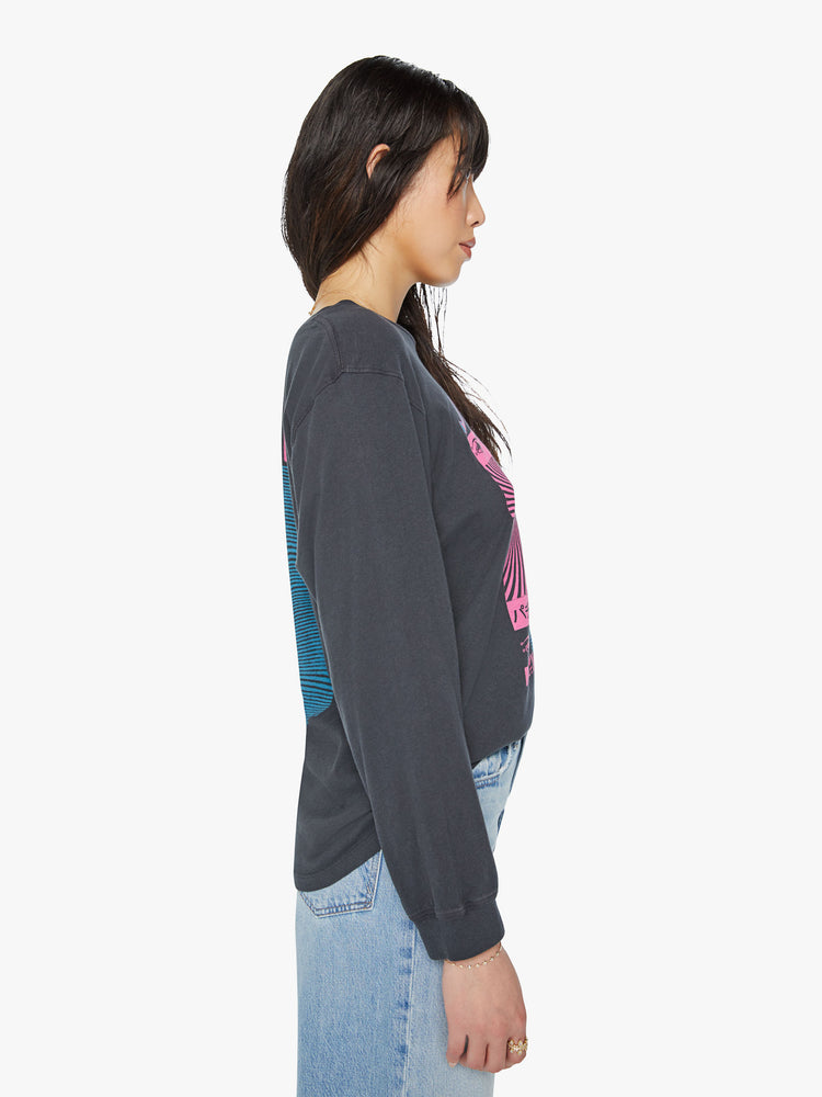 Side view of a woman crewneck tee with an oversized fit in a faded black tee features neon pink and blue graphics inspired by a pachinko parlor.