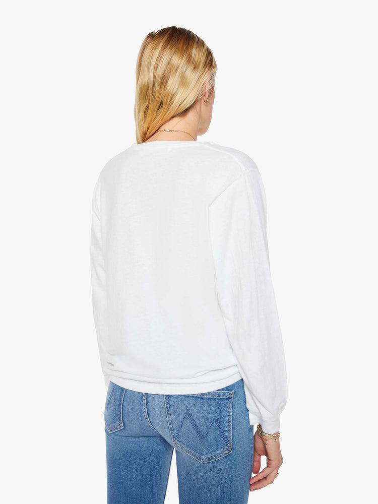 Back  view of a woman crewneck tee with long sleeves and an oversized fit in a bight white hue.