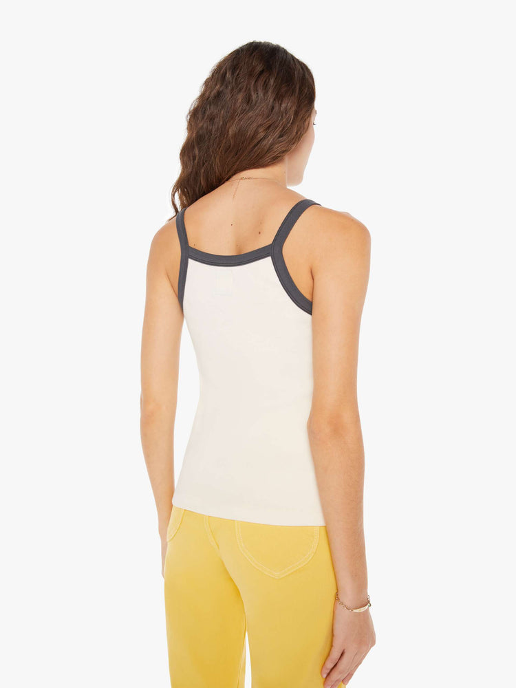Back view view of a woman in a vintage-inspired tank designed with thin straps, a narrow fit and a slightly longer hemline.