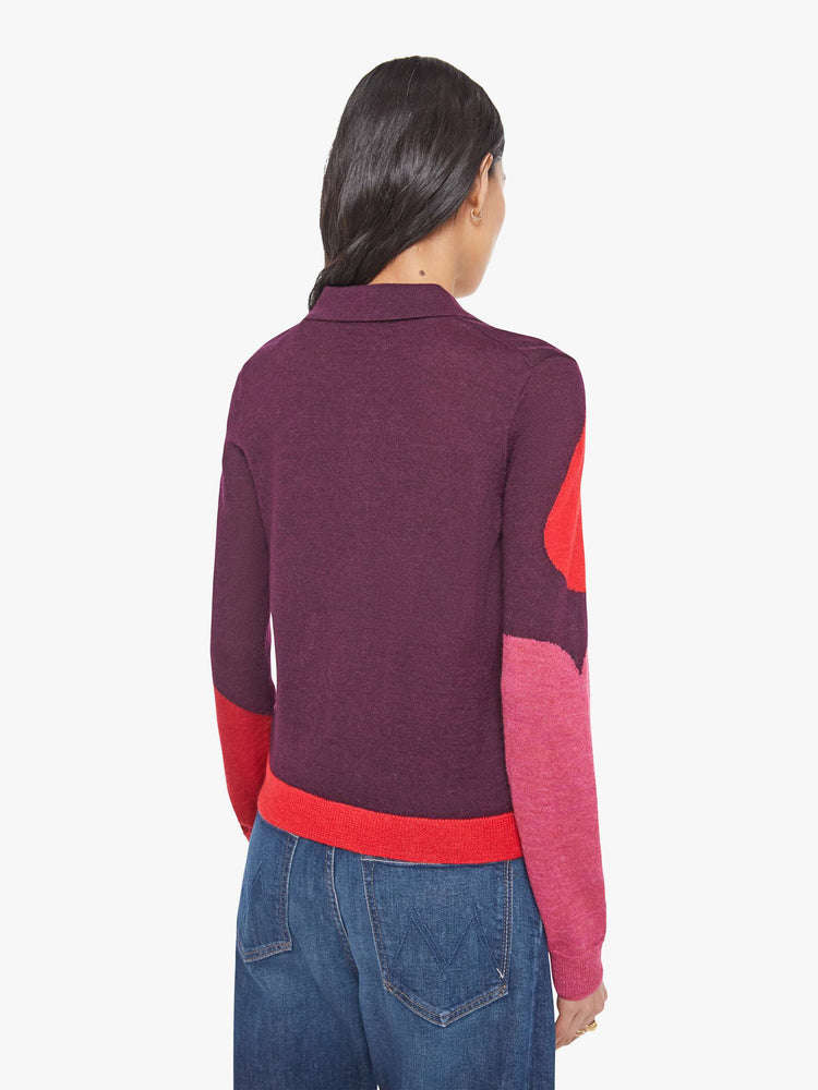 Back view of a maroon and pink collared cardigan sweater with long sleeves, ribbed hems and a loose fit. 