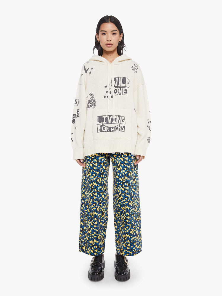 Full  body view of a woman in an  oversized knit hoodie with drop shoulders, a front patch pocket and ribbed hems with a distressed edge. body 