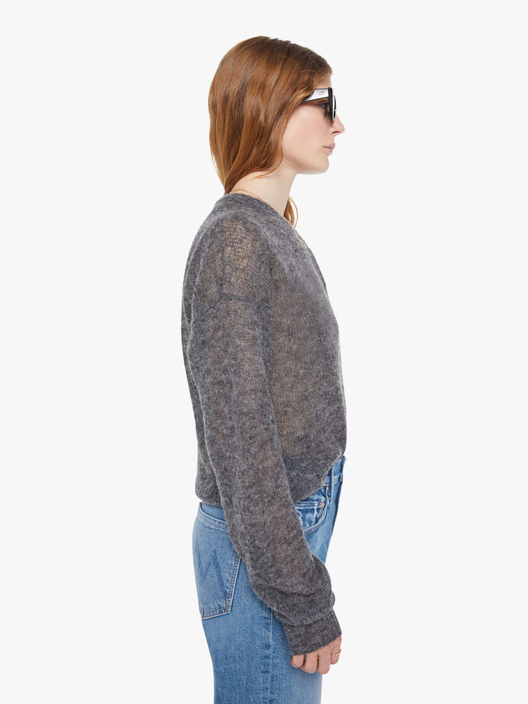 Side view of a woman in a sheer grey woo cardigan with MOTHERS name patched on the chest.