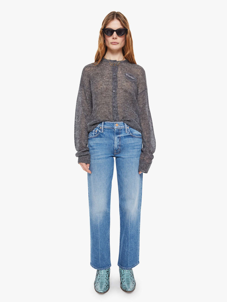 Full body view of a woman in a sheer grey woo cardigan with MOTHERS name patched on the chest.