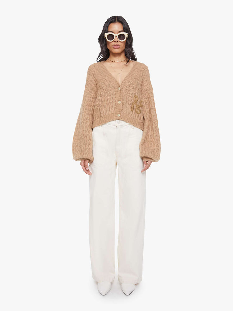 Full body  view of a woman in a light khaki  V-neck cardigan with drop shoulders, oversized balloon sleeves, ribbed hems and a cropped fit. 