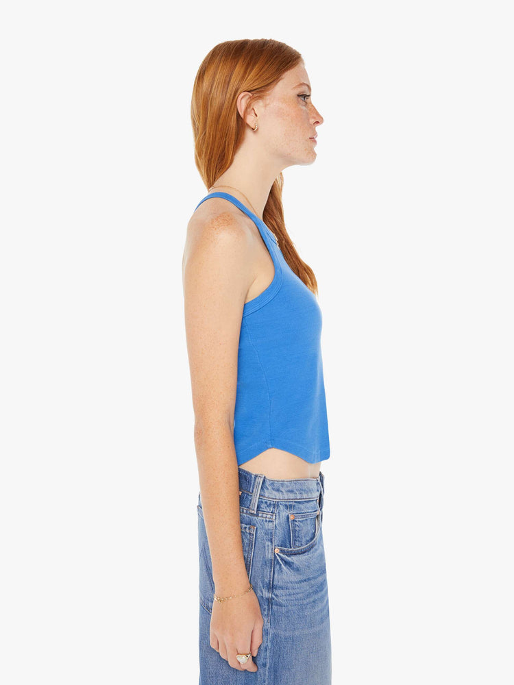 Side view of a woman in a royal blue tank features a slim fit, racer-style straps that cross in the back and a slightly curved hem.
