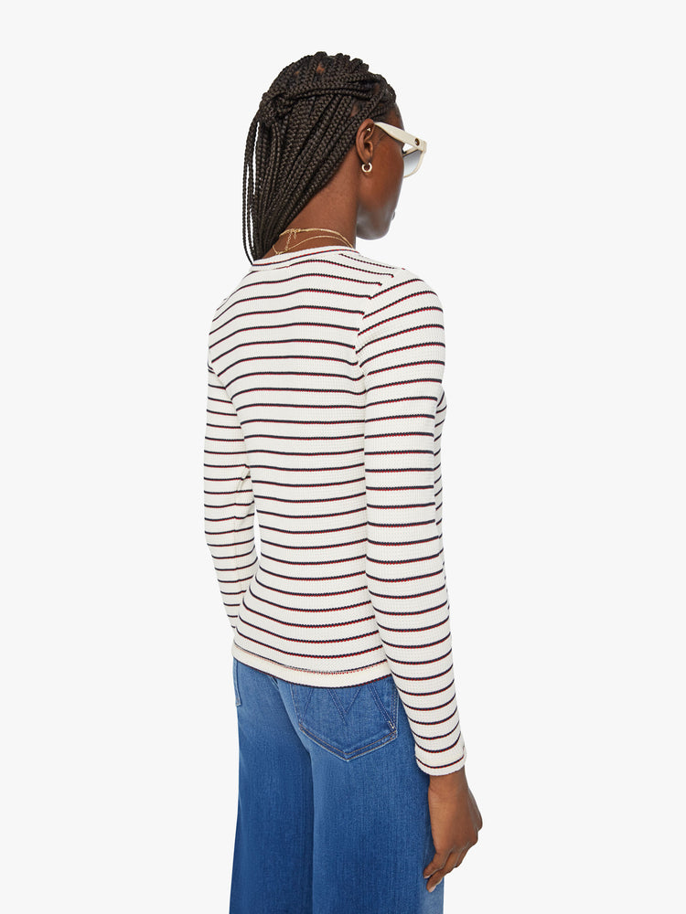 Back view of a woman long sleeve thermal with a buttoned crewneck and a narrow fit in cream with navy and red stripes.