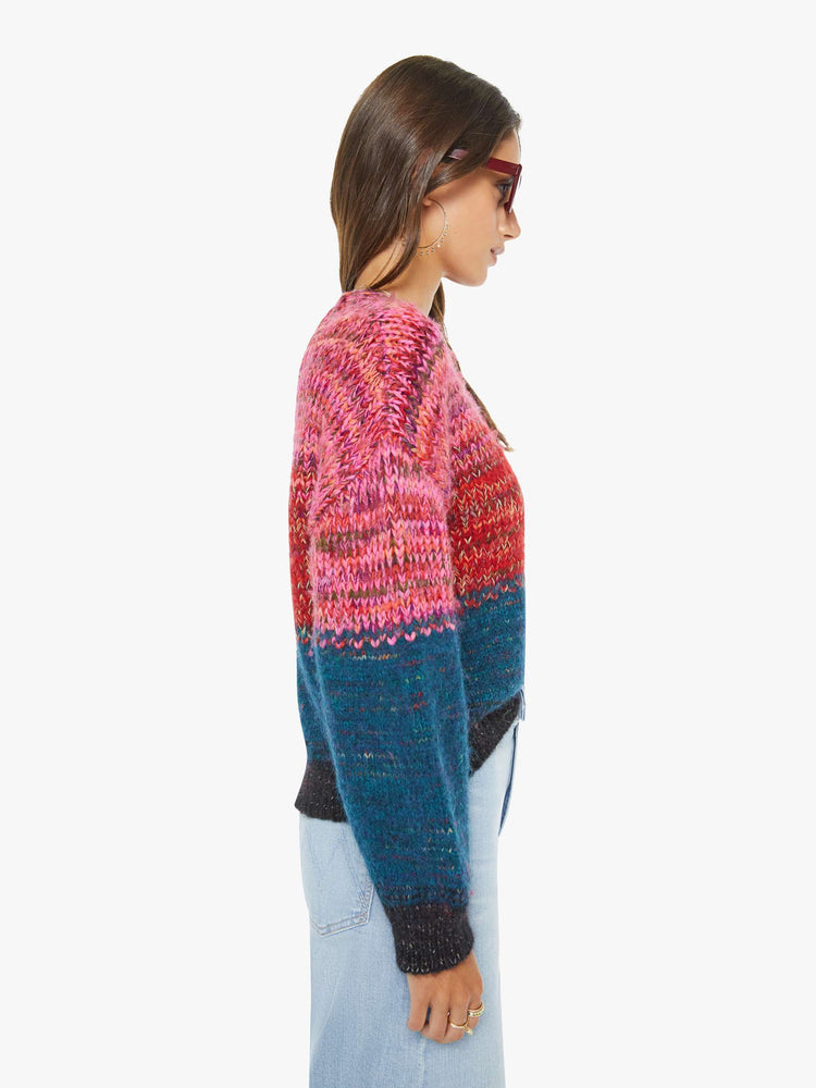 Side view of a woman in multi color  cropped crewneck sweater with drop shoulders, ribbed hems and an oversized fit. 