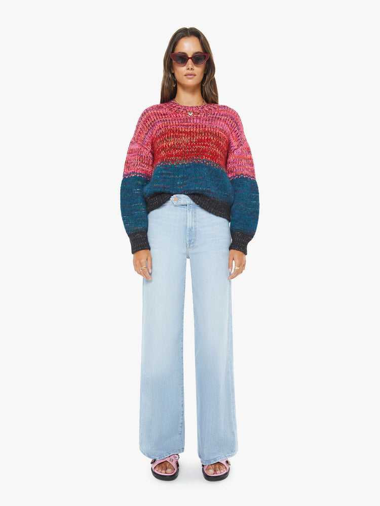 Full body view of a woman in multi color  cropped crewneck sweater with drop shoulders, ribbed hems and an oversized fit. 