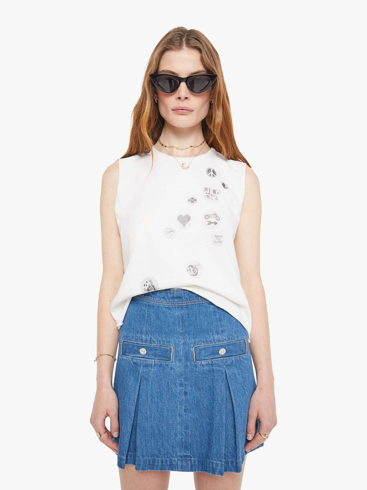 Front view of a woman in a slightly sheer crewneck with chopped sleeves and a slim fit for a vintage look and feel. 