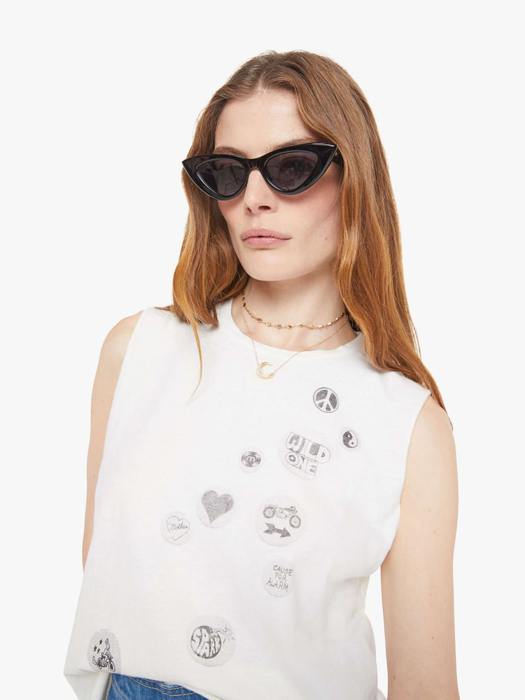 Close up  view of a woman in a slightly sheer crewneck with chopped sleeves and a slim fit for a vintage look and feel. 