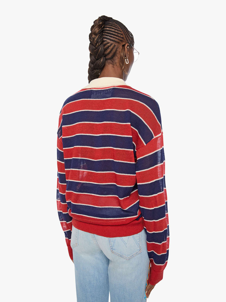 Back view of a woman in a red and navy stripes with a cream collar and button placket rugby polo with this long-sleeve top featuring drop shoulders and an oversized fit.