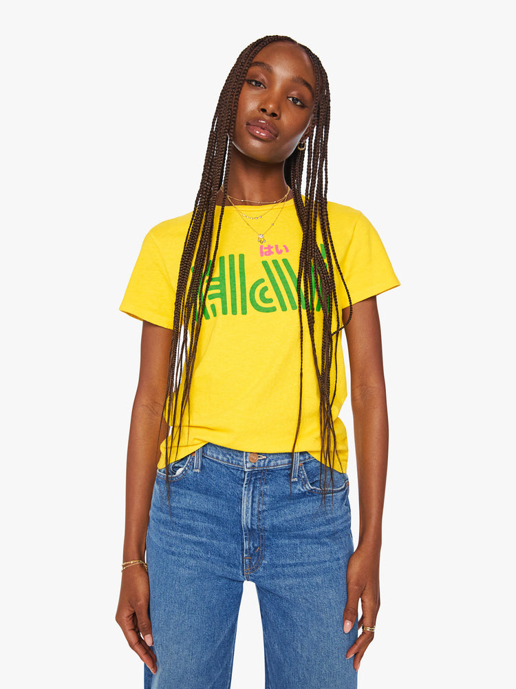 Front view of a woman bright yellow tee features a pink and green text graphic on the front.