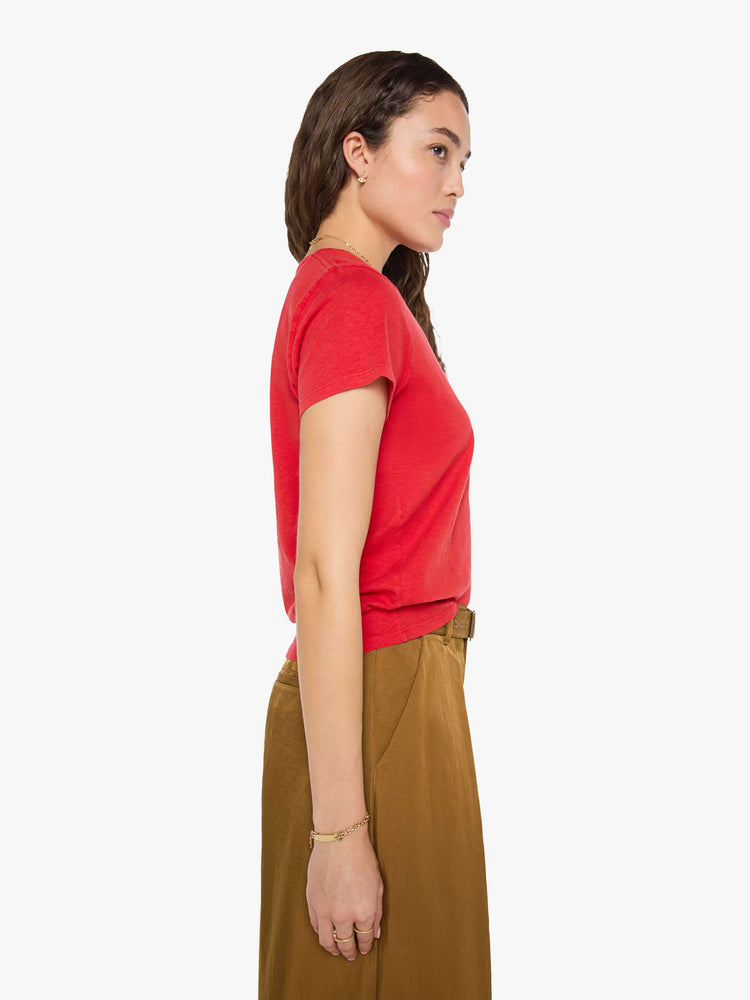 Side view of a woman in red tee features a bird graphic and text in grey on the front.