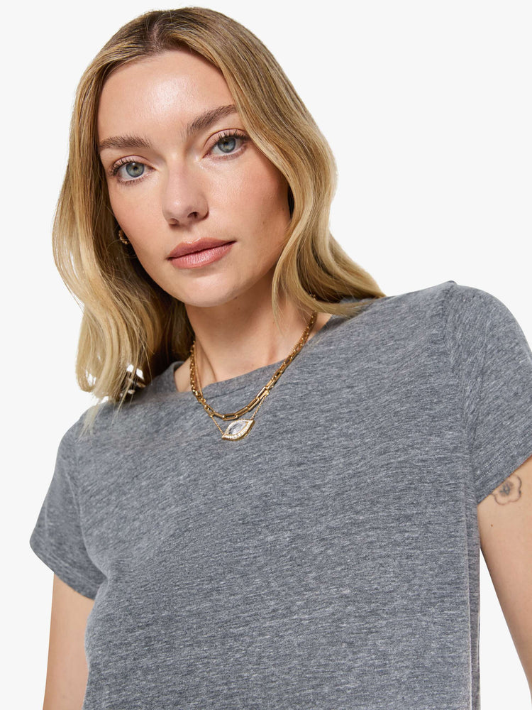 Close up view of a womens heather grey crew neck tee featuring a slim fit.