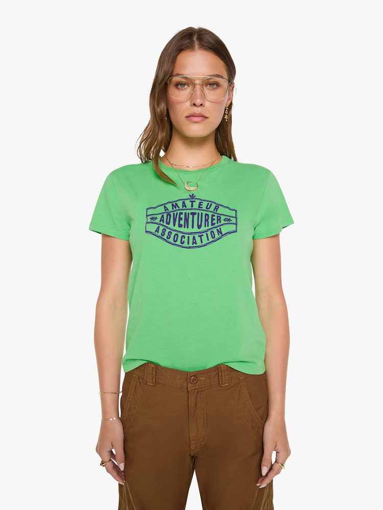 Front view of a woman in a lime green tee with a navy text graphic on the front.
