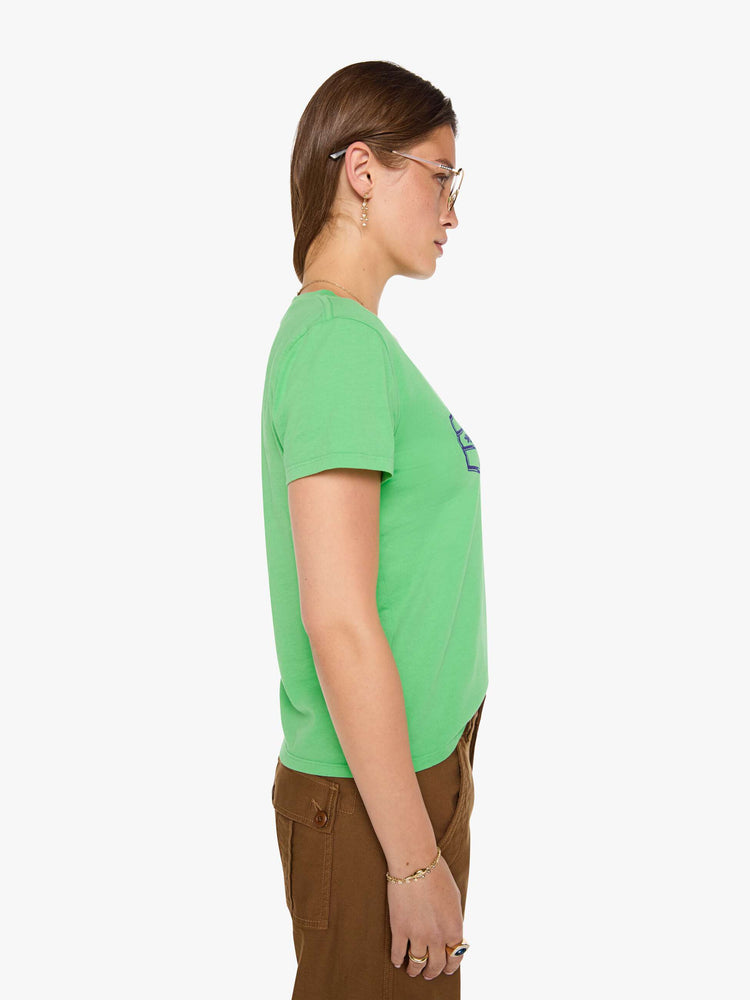 Side view of a woman in a lime green tee with a navy text graphic on the front.