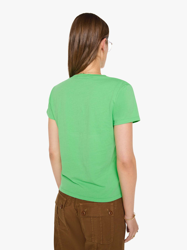 Back view of a woman in a lime green tee with a navy text graphic on the front.