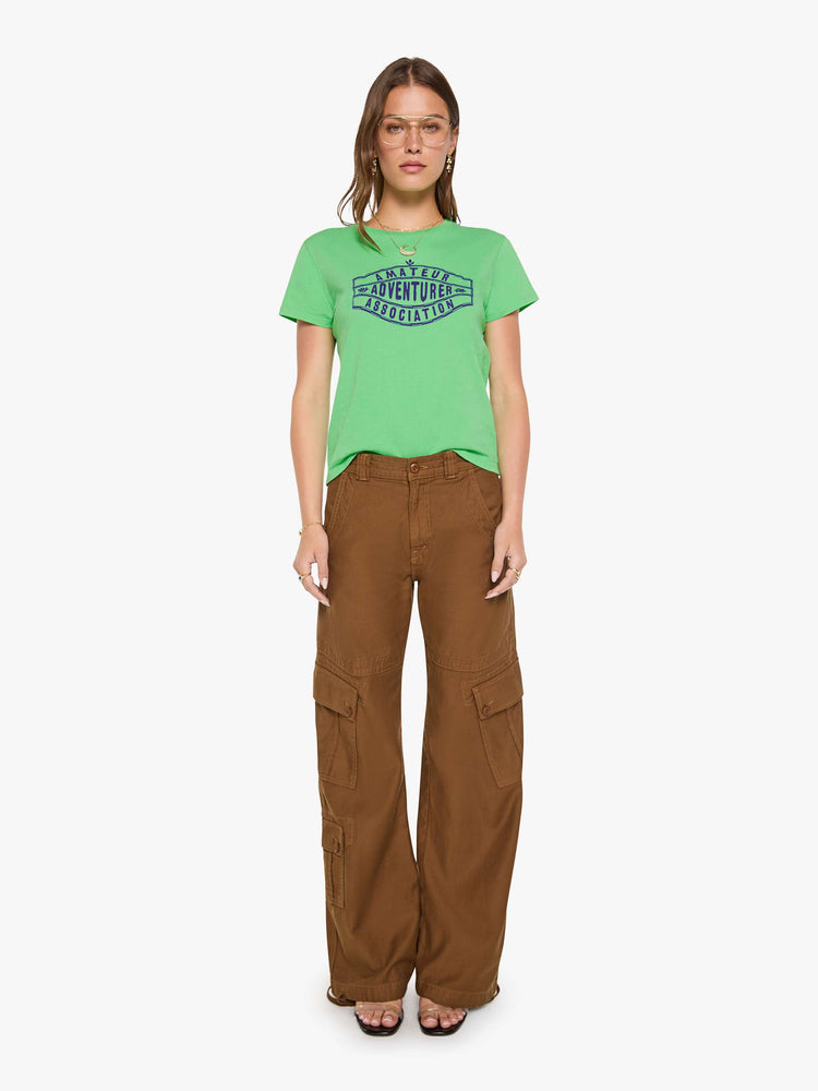 Full body view of a woman in a lime green tee with a navy text graphic on the front.