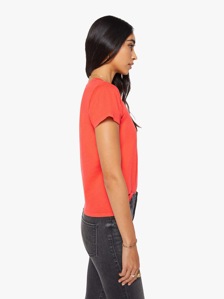 Side view of a woman in a bright orange crewneck with a slim fit for a vintage look and feel.