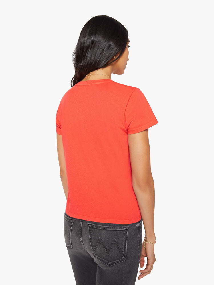Back view of a woman in a bright orange crewneck with a slim fit for a vintage look and feel.