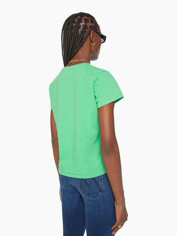 Back view of a woman bright green tee features white graphic text on the front.