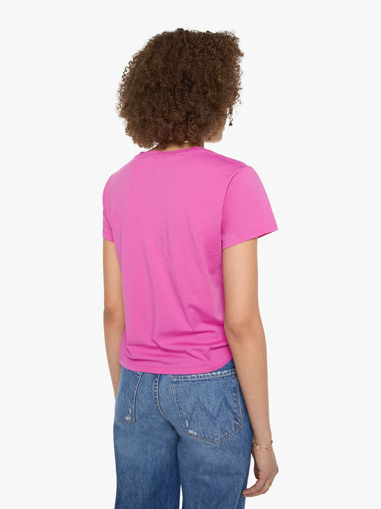 Back view of a woman in a bright pink tee with a celestial saloon graphic in yellow across the chest.