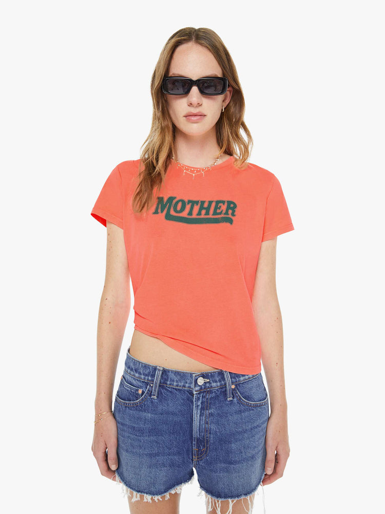 Front view of a woman in a neon orange tee features MOTHER's name in green on the front. 